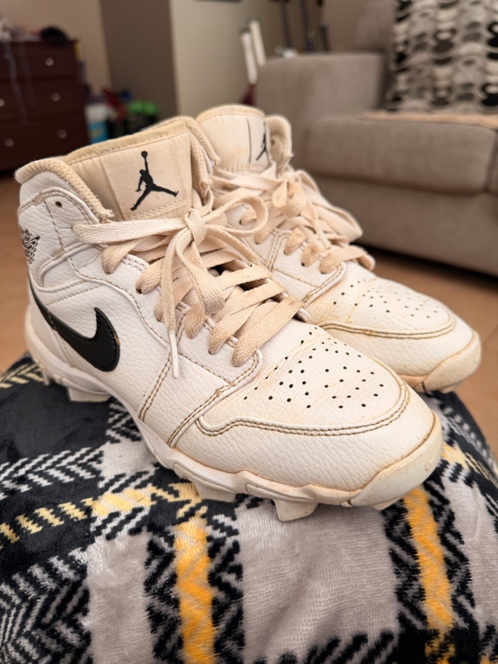 Used Jordan High-Top cleats in Cream with Black Swoosh